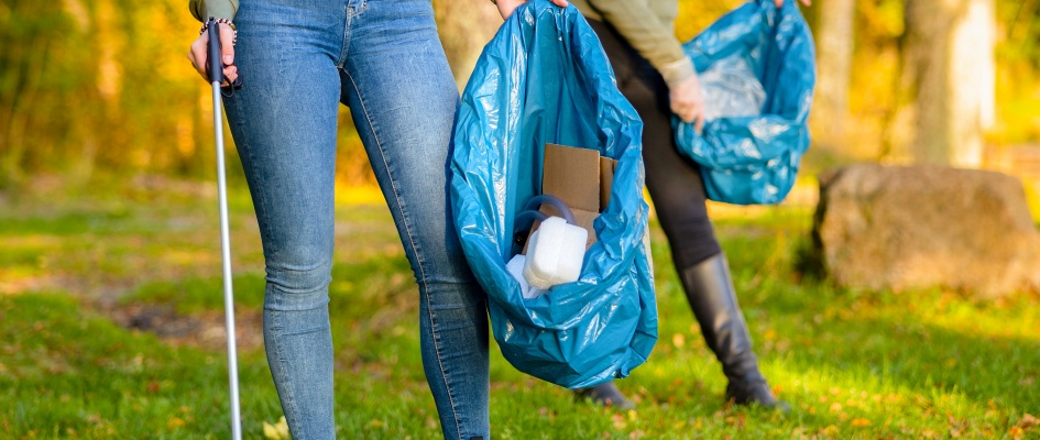 female-volunteers-picking-up-garbage-on-grass-2023-11-27-05-26-21-utc